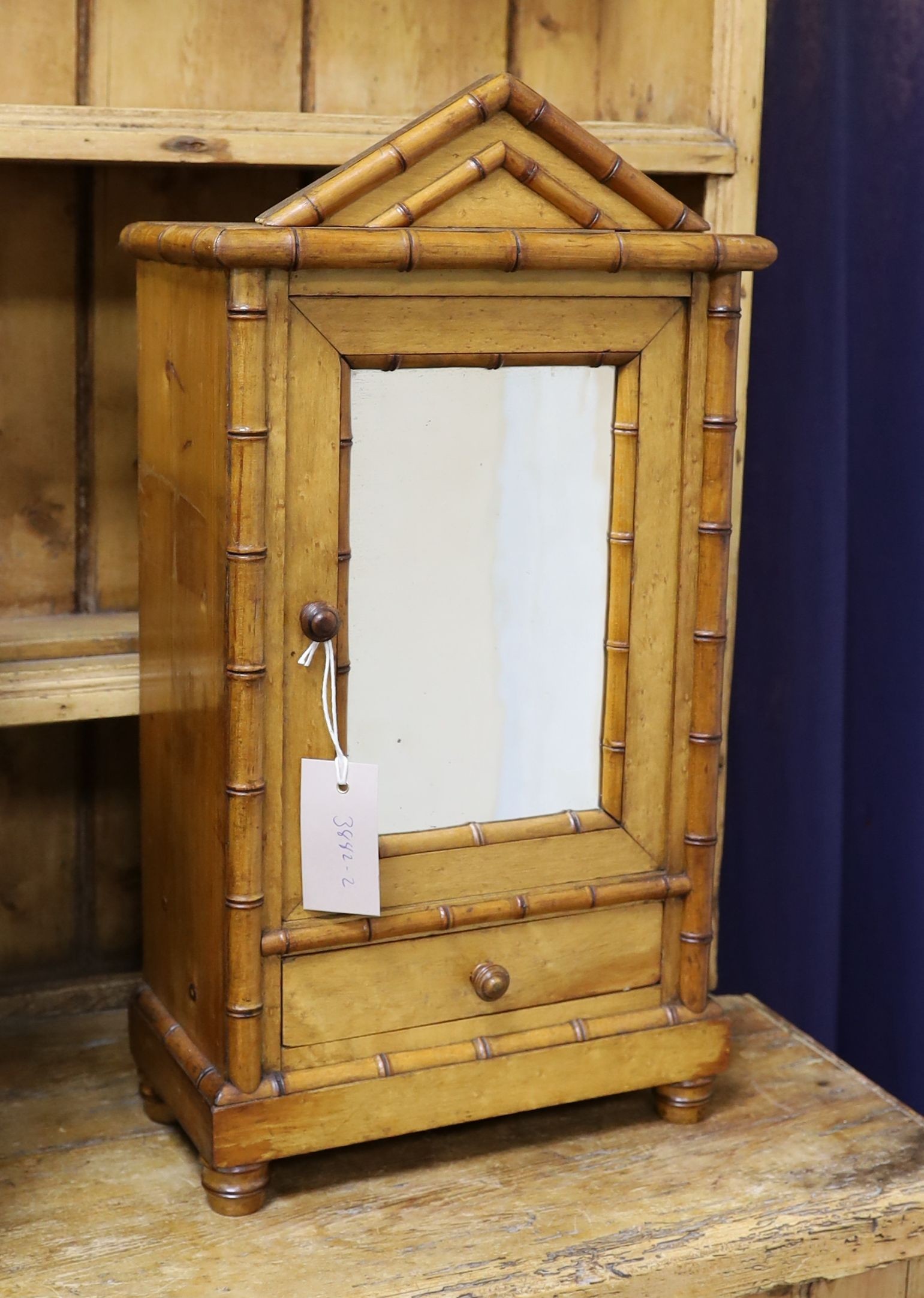A 19th century French miniature birds eye maple and pine armoire, width 27cm, depth 14cm, height 50cm